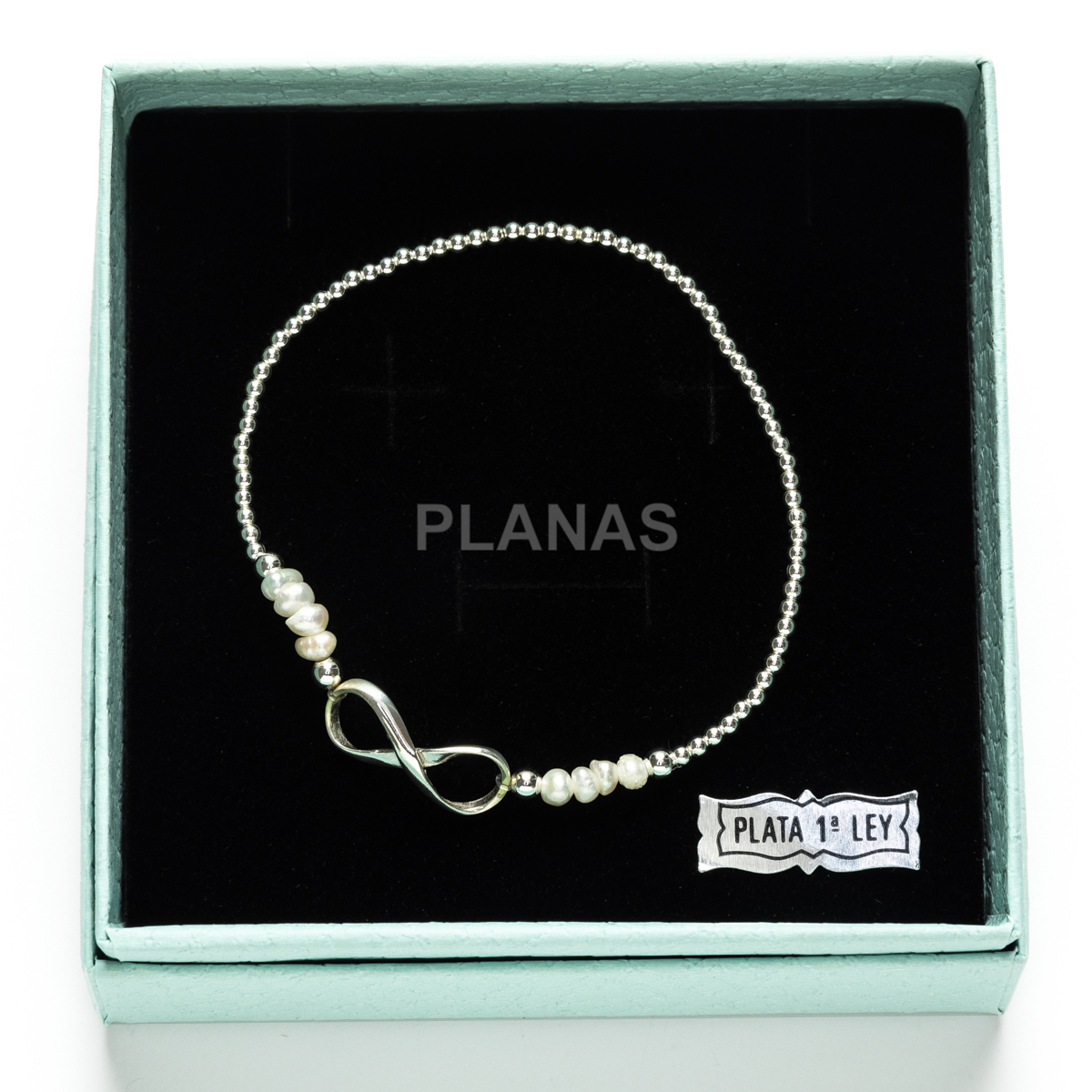 Pulseira elástica em prata de lei e pérolas cultivadas. infinito.
