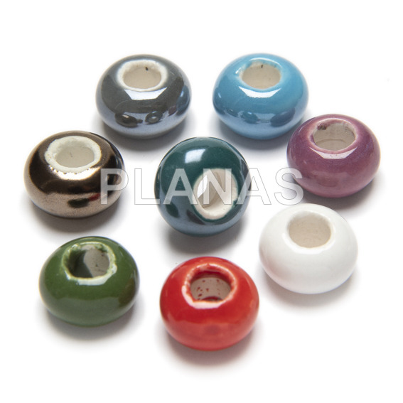 Pack of 10 porcelain beads, assorted colors.