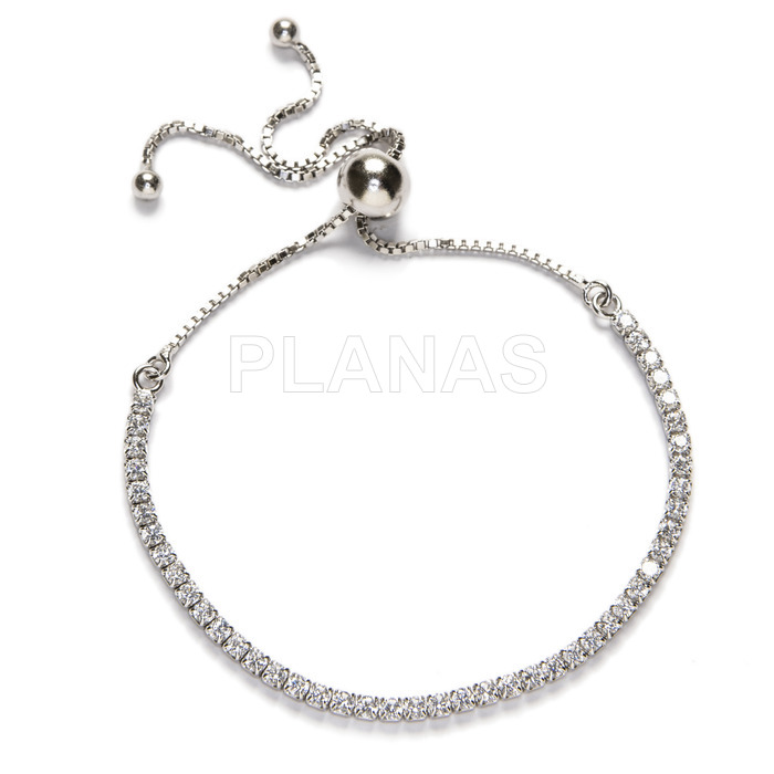 Rhodium plated sterling silver and white zircons bracelet with sliding closure.