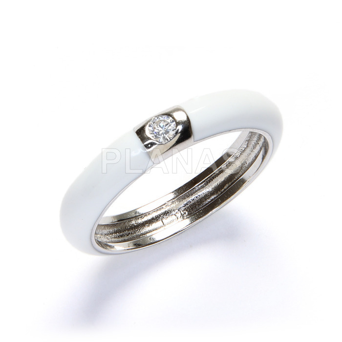 Rhodium plated sterling silver ring with zirconia and white enamel.