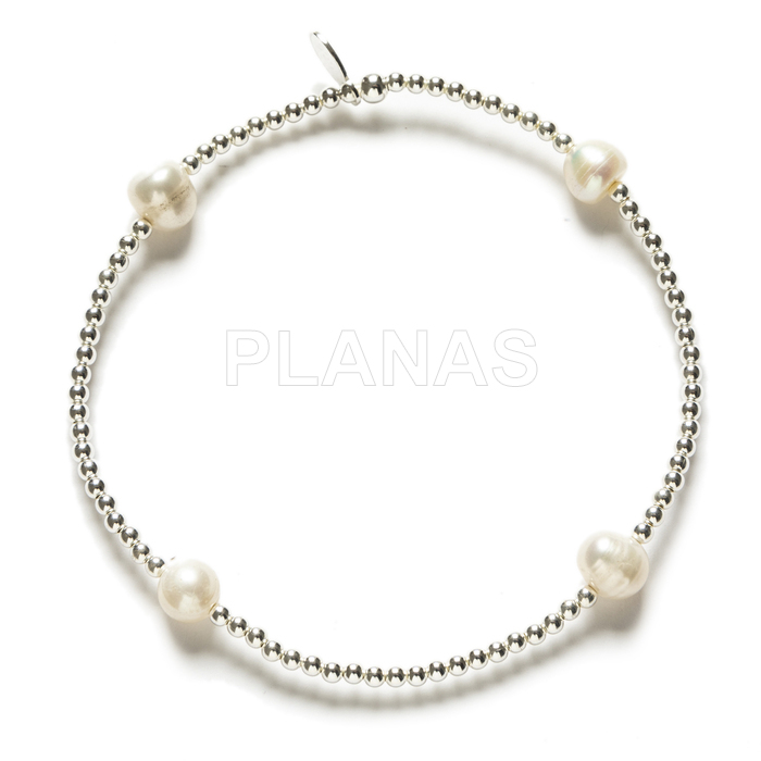 Elastic bracelet in sterling silver and cultured pearls.