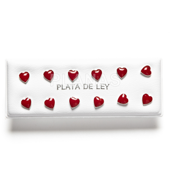 Display of 6 pieces of red enameled sterling silver earrings. heart.