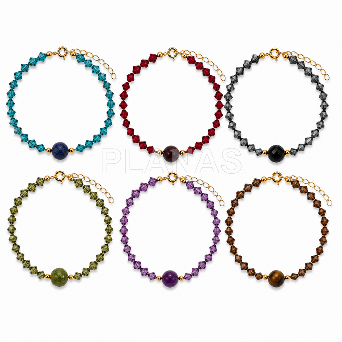 Pulseira em prata de lei com banho de ouro, com detalhes em mineral e cristais swarovski.